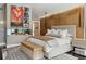 Modern main bedroom with wood-accent walls, a gas fireplace, and a plush upholstered bench at 1640 E Adams Dr, Maitland, FL 32751