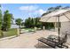Spacious patio with stone floors, lounge chairs, umbrellas, and lake views perfect for relaxing and entertaining outdoors at 1640 E Adams Dr, Maitland, FL 32751