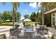 Poolside patio with seating, lush landscaping, and views of the lake creating a serene outdoor living space at 1640 E Adams Dr, Maitland, FL 32751