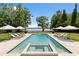 Beautiful swimming pool with spa, lounge chairs, and lake views surrounded by lush green lawns at 1640 E Adams Dr, Maitland, FL 32751