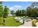 Aerial view of sparkling pool with lounge chairs, umbrellas, and lush greenery, creating a private backyard oasis at 1640 E Adams Dr, Maitland, FL 32751