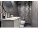 Chic powder room with patterned wallpaper, modern vanity, and elegant fixtures, offering a stylish space at 1640 E Adams Dr, Maitland, FL 32751