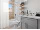 Bathroom with modern decor with a tub and shower combination, shelving, and a vanity at 16927 Sw 25Th Terrace Rd, Ocala, FL 34473