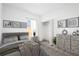 A bedroom with neutral tones, decorated with modern art and an area rug under the bed at 16927 Sw 25Th Terrace Rd, Ocala, FL 34473