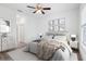 Cozy bedroom with neutral decor, laminate flooring, a ceiling fan, and a window view at 16927 Sw 25Th Terrace Rd, Ocala, FL 34473