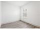 Empty bedroom showcasing neutral walls, a window with blinds, and wood-style flooring at 16927 Sw 25Th Terrace Rd, Ocala, FL 34473