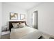 A comfortable bedroom decorated with modern art, neutral tones, and wood-style flooring at 16927 Sw 25Th Terrace Rd, Ocala, FL 34473
