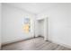 Bright bedroom featuring sleek wood floors, a window letting in natural light, and a closet at 16927 Sw 25Th Terrace Rd, Ocala, FL 34473