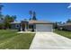 Charming single-story home featuring a well-manicured lawn and a two-car garage at 16927 Sw 25Th Terrace Rd, Ocala, FL 34473