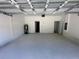 Garage featuring a hot water heater, electrical panel, and two doors at 16927 Sw 25Th Terrace Rd, Ocala, FL 34473