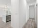 Hallway leading to the kitchen with stainless steel appliances and bright lighting at 16927 Sw 25Th Terrace Rd, Ocala, FL 34473