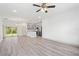 Open-concept living space with modern gray cabinets, a peninsula, and sliding glass doors at 16927 Sw 25Th Terrace Rd, Ocala, FL 34473