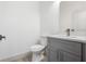 Powder room features gray vanity with modern sink and fixtures at 16927 Sw 25Th Terrace Rd, Ocala, FL 34473
