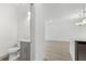 View of a powder room with gray vanity and sleek fixtures, leading into an open-concept space at 16927 Sw 25Th Terrace Rd, Ocala, FL 34473