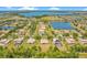 Panoramic aerial view of homes in a lakeside community with mature trees and attractive landscaping at 18108 Bellezza Dr, Orlando, FL 32820
