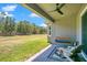 Relaxing covered back porch with a fan, swing, and outdoor seating, perfect for enjoying the yard at 18108 Bellezza Dr, Orlando, FL 32820