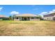 View of the back of house including the lawn and slider door at 18108 Bellezza Dr, Orlando, FL 32820