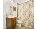 Bathroom view with a wood vanity, toilet, and floral shower curtain at 18108 Bellezza Dr, Orlando, FL 32820