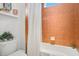 Close-up of bathroom including toilet, tiled shower and white curtain at 18108 Bellezza Dr, Orlando, FL 32820
