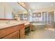 Large bathroom with double sink vanity, soaking tub, glass shower, and tile floors at 18108 Bellezza Dr, Orlando, FL 32820