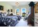 Bedroom featuring two beds, a chandelier, arched windows with natural light, and elegant decor at 18108 Bellezza Dr, Orlando, FL 32820