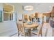 Cozy dining area with round wood table, four chairs, and open view to the kitchen at 18108 Bellezza Dr, Orlando, FL 32820