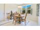 A view of the dining area showing a round wood table and four chairs at 18108 Bellezza Dr, Orlando, FL 32820