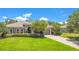 Charming single-story home with a well-manicured lawn, lovely landscaping, and a brick-paved driveway at 18108 Bellezza Dr, Orlando, FL 32820