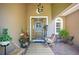 Inviting front porch with decor, seating, and a charming front door to welcome you home at 18108 Bellezza Dr, Orlando, FL 32820