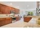 Bright kitchen featuring granite countertops, stainless steel appliances, and wooden cabinets at 18108 Bellezza Dr, Orlando, FL 32820