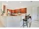A kitchen view with a granite countertop island, stainless steel appliances, and wooden cabinets at 18108 Bellezza Dr, Orlando, FL 32820