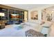 Bright living room with large windows, archways, a modern entertainment center, and plush seating at 18108 Bellezza Dr, Orlando, FL 32820