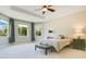 Spacious main bedroom with tray ceiling, three windows, and neutral decor at 18108 Bellezza Dr, Orlando, FL 32820