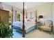 Cozy bedroom with four-poster bed, soft lighting, and decorative pillows at 18108 Bellezza Dr, Orlando, FL 32820