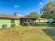 A large backyard with a screened in porch and mature trees and shed at 1872 N Akron Dr, Deltona, FL 32738
