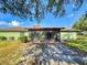 A large backyard with a screened in porch and mature trees on a sunny day at 1872 N Akron Dr, Deltona, FL 32738