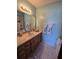 Bathroom with vanity, decorative mirror, and updated fixtures at 1872 N Akron Dr, Deltona, FL 32738