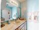 Well-lit bathroom featuring a stylish sink, shower, and mirror with light blue tiling at 1872 N Akron Dr, Deltona, FL 32738