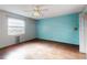 Bright bedroom with wood-look floors and a frosted glass window at 1872 N Akron Dr, Deltona, FL 32738