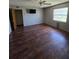 Bedroom with wood floors, ceiling fan, and large window at 1872 N Akron Dr, Deltona, FL 32738