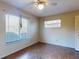 Bright bedroom featuring two windows, a ceiling fan, and vinyl flooring at 1872 N Akron Dr, Deltona, FL 32738