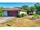 Charming home featuring a wide two-car garage and well-maintained landscaping at 1872 N Akron Dr, Deltona, FL 32738