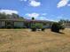 Charming one-story home featuring a well-maintained lawn and attractive landscaping under a bright blue sky at 1872 N Akron Dr, Deltona, FL 32738