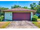 A home with a wide driveway and a two-car garage with a maroon garage door at 1872 N Akron Dr, Deltona, FL 32738