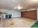 Spacious garage featuring a trash can and ample storage and workspace at 1872 N Akron Dr, Deltona, FL 32738