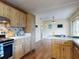 Bright kitchen with wood-look floors, white countertops, wood cabinets, and stainless steel appliances at 1872 N Akron Dr, Deltona, FL 32738