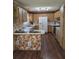 Open kitchen with wood cabinets, updated appliances, and charming floral accents at 1872 N Akron Dr, Deltona, FL 32738