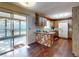 Open kitchen with wood-style cabinets, breakfast bar, and sliding door to outdoor space at 1872 N Akron Dr, Deltona, FL 32738