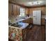 Well-lit kitchen with wood cabinetry, modern appliances, and breakfast bar seating at 1872 N Akron Dr, Deltona, FL 32738