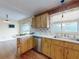 Cozy kitchen features wood cabinets, countertop dining, stainless steel dishwasher, and a double basin sink at 1872 N Akron Dr, Deltona, FL 32738